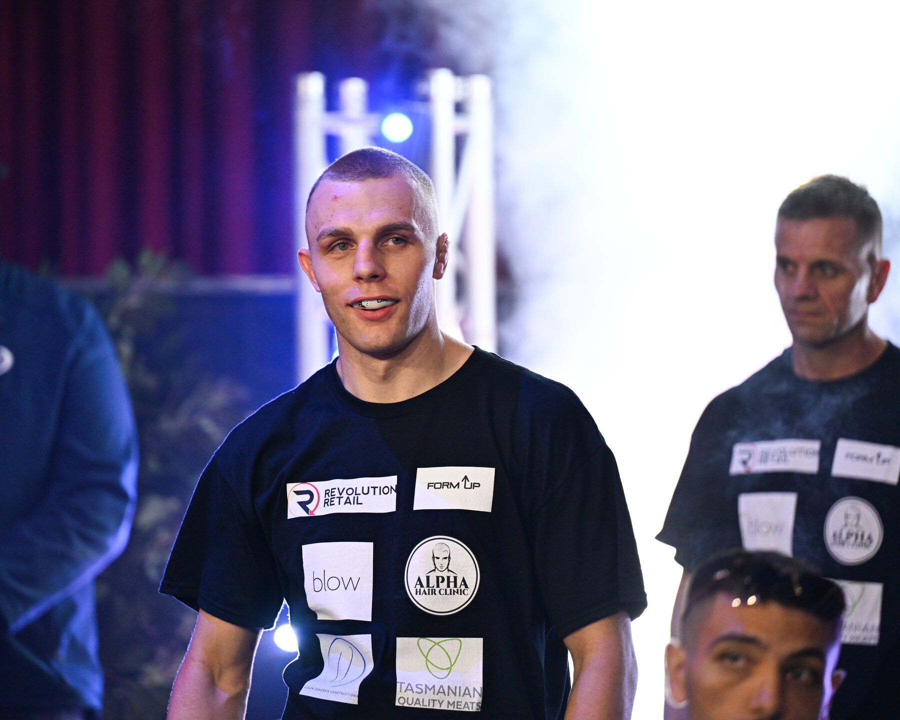 Dan's hand raised in victory by the referee